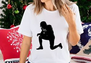 American football player in a kneeling position on the field in black silhouette
