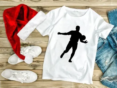 Silhouette of a man playing soccer or football with a ball