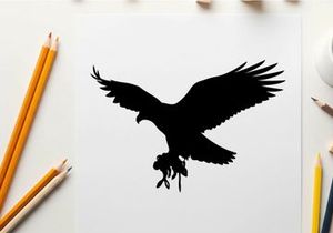 Silhouette of an eagle in flight with outstretched wings and talons extended