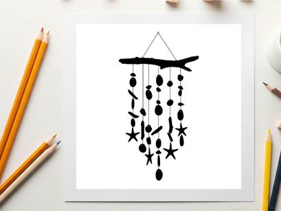 Silhouette of a driftwood wind chime with starfish and sea inspired shapes