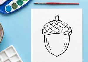 Close-up of an acorn on a white background. Natural nut with textured cap, detailed macro shot.