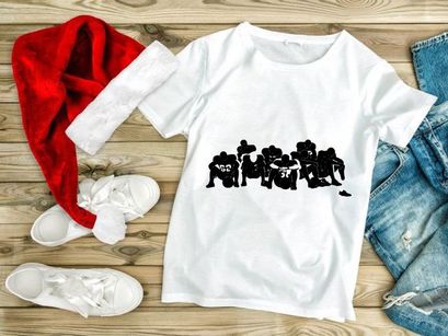 Blurry black and white photo of football players sitting in a row on the ground together