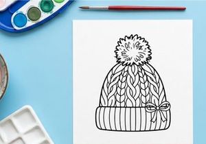 Winter knit beanie hat with pom pom and bow, black and white line art illustration.
