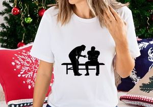 Silhouette of a coach talking to a seated athlete on a bench