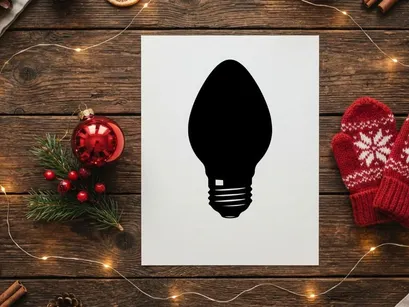 Black silhouette of a classic light bulb isolated on a white background.