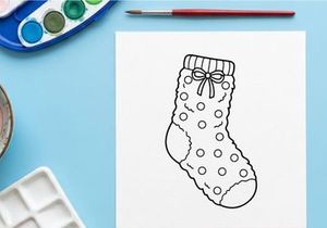 Christmas stocking line art drawing with polka dot pattern and decorative bow icon