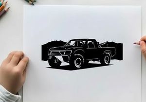 Silhouette of a pickup truck in front of mountains