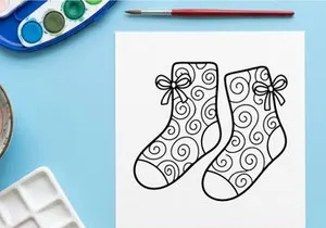Pair of festive Christmas socks with snowflake and bow designs for holiday celebrations
