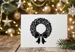 Black and white Christmas wreath illustration with pine cones and a decorative bow