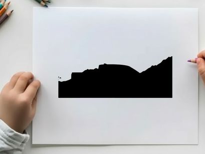 Silhouette of a pickup truck in front of a mountain range silhouette
