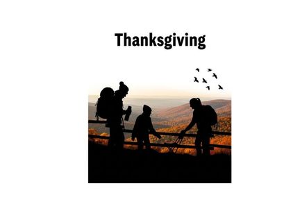 Thanksgiving silhouette of family on a hill watching birds fly