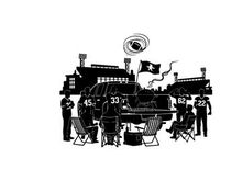 Silhouette of people gathered around a vehicle with a flag