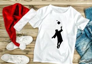 Graduate throwing cap in air, silhouette, graduation celebration