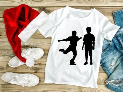 Two black silhouettes of boys playing soccer on a white background