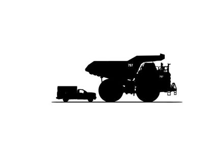 Silhouette of a large mining truck and small transport vehicle