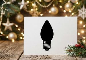 Black silhouette of a Christmas light bulb isolated on a white background