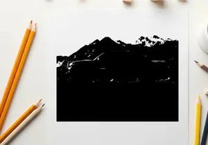 Silhouette of a pickup truck in front of a mountain range