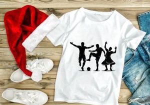 Silhouette of three people playing soccer and dancing together