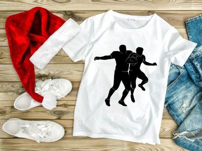 Two american football players in action one holding the ball