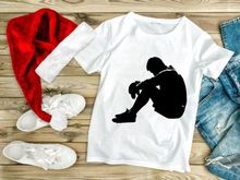 A person sitting alone in a state of sadness or despair on the ground