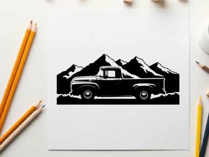 Silhouette of a vintage pickup truck in front of majestic mountain range silhouette