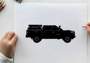 Silhouette of a pickup truck with a camper on the back