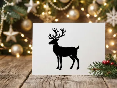 Black silhouette of a reindeer with large antlers isolated on a white background
