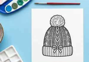 Hand-drawn winter knit hat with snowflake pattern and pom pom for festive holiday fashion