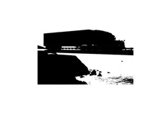Silhouette of a large building near a body of water