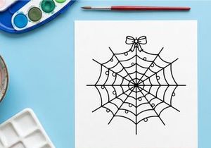 Hand-drawn black and white spider web with decorative bow. Minimalist line art web illustration for Halloween or nature-themed designs.