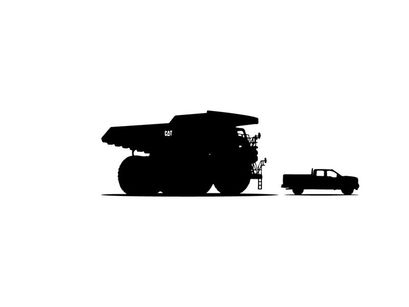 Silhouette of a large mining truck and a small pickup truck