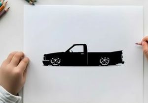 Silhouette of a lowered pickup truck with custom wheels
