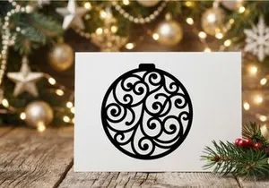 Black Christmas bauble silhouette with intricate swirl pattern isolated on white background