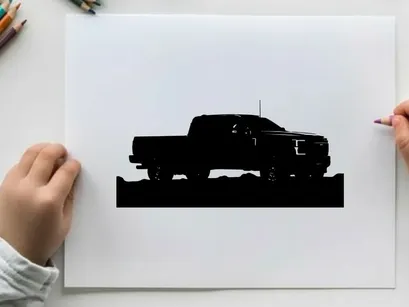 Silhouette of a pickup truck against a mountain range silhouette