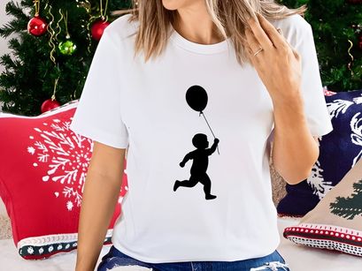 Silhouette of a toddler boy running with a balloon