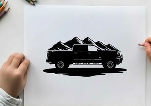 Silhouette of a pickup truck in front of mountains
