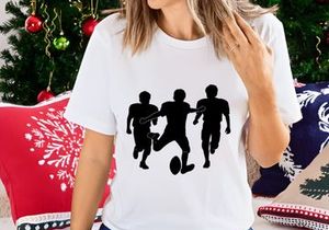 Three silhouette football players in action running with ball