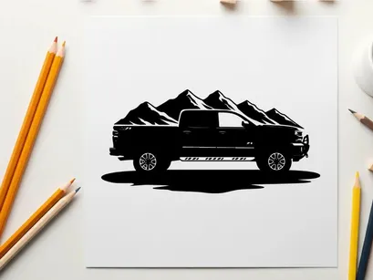 Silhouette of a pickup truck in front of mountains