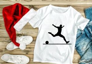 Silhouette of a soccer player kicking a ball in mid air motion