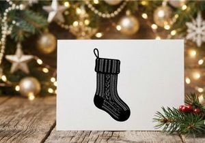 Black and white knitted Christmas stocking isolated on a clean white background
