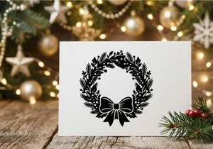Black Christmas wreath silhouette with bow isolated on white background