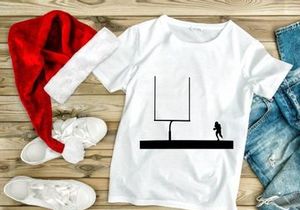 American football player approaching goal post silhouette