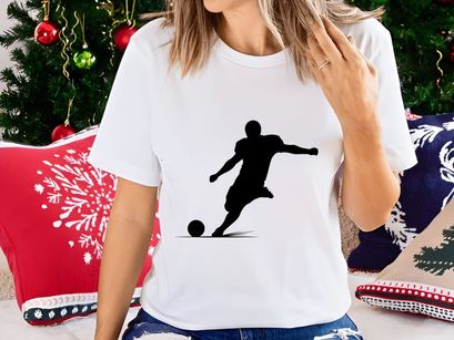 Soccer player kicking a ball in mid action silhouette