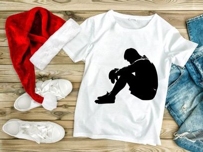 A person sitting alone in a state of sadness or despair on the ground