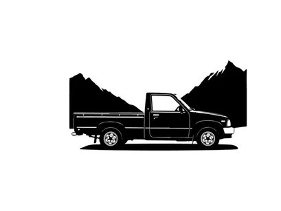 Silhouette of a pickup truck in front of mountains
