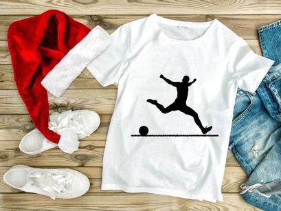 Silhouette of a soccer player kicking a ball in mid air motion