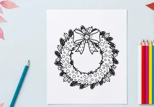 Página para colorear de corona navideña con moño festivo y hojas de acebo para proyectos de arte navideño