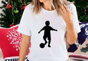 Silhouette of a boy playing soccer with a ball on a white background