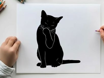 Silhouette of a black cat sitting and pawing at its face
