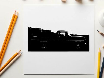 Silhouette of a classic pickup truck in front of a mountain range silhouette